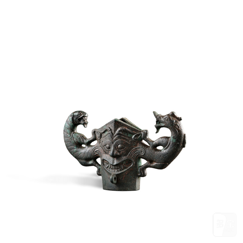 A rare archaic bronze 'dragon and tiger' spear guard, Han dynasty | 漢 青銅龍虎紋鎩格